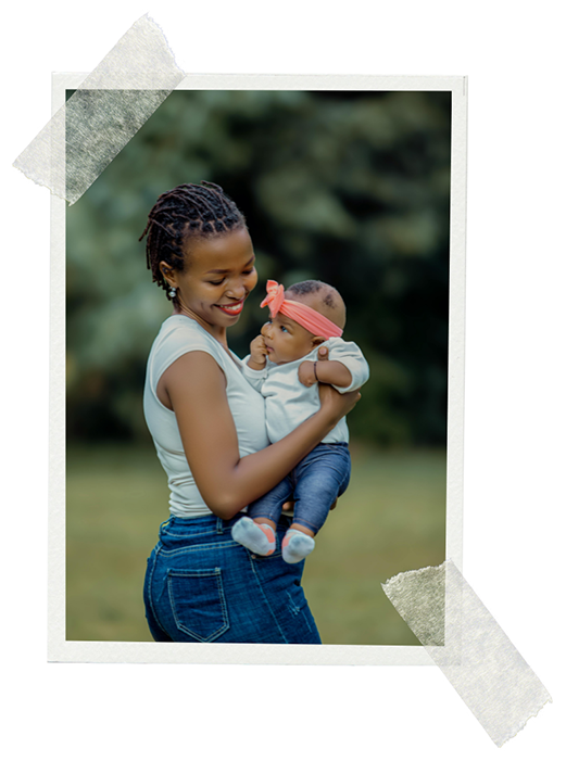 Photo of a lady holding a baby outside